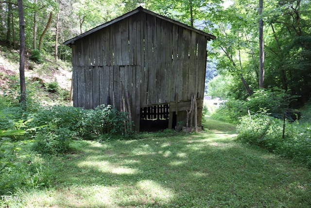 view of outdoor structure featuring a lawn