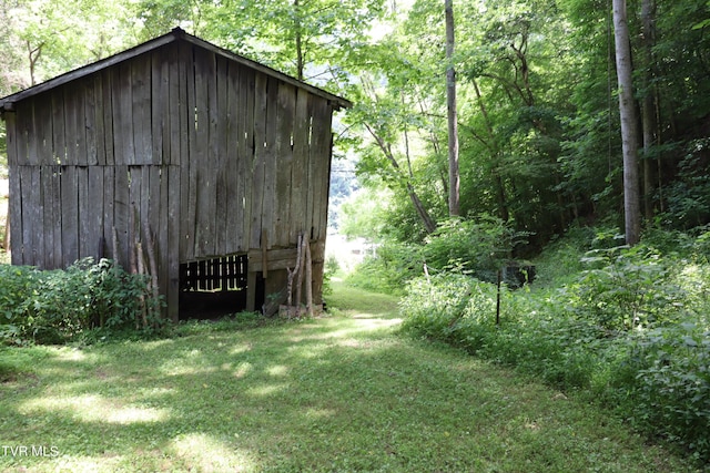 view of outbuilding with a lawn