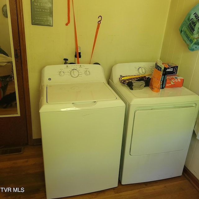 laundry area featuring independent washer and dryer and wood-type flooring