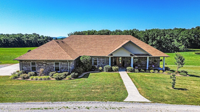 single story home with a front yard and covered porch