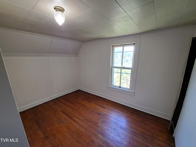 bonus room featuring dark hardwood / wood-style floors and vaulted ceiling