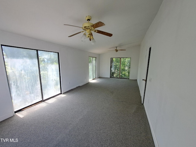 carpeted spare room with ceiling fan and lofted ceiling