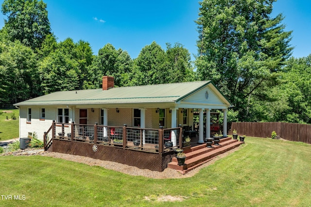 back of house with a porch and a yard