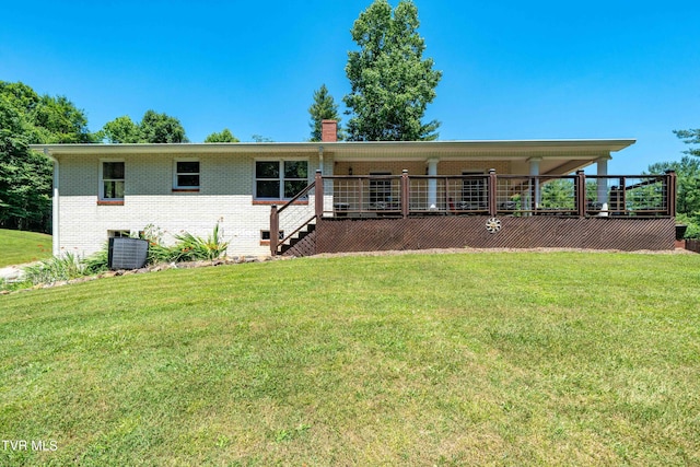 view of front of property featuring a deck, central air condition unit, and a front yard