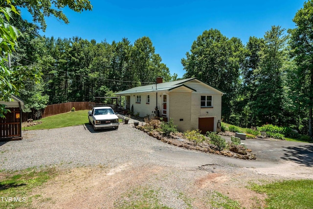 view of front of home with a garage and a front lawn