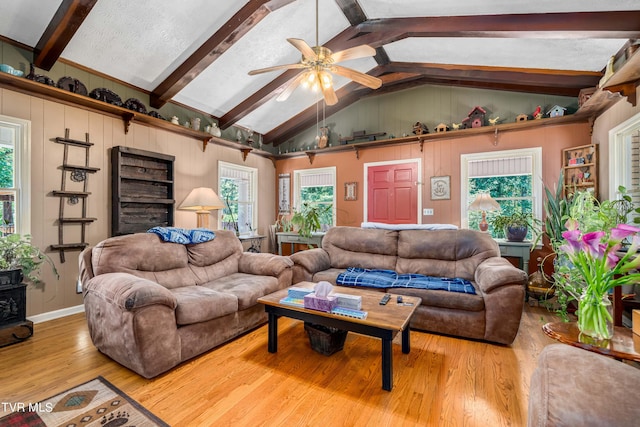 living room featuring a textured ceiling, vaulted ceiling with beams, hardwood / wood-style flooring, and ceiling fan