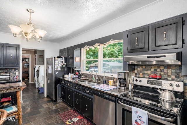 kitchen featuring backsplash, sink, stainless steel appliances, and a textured ceiling