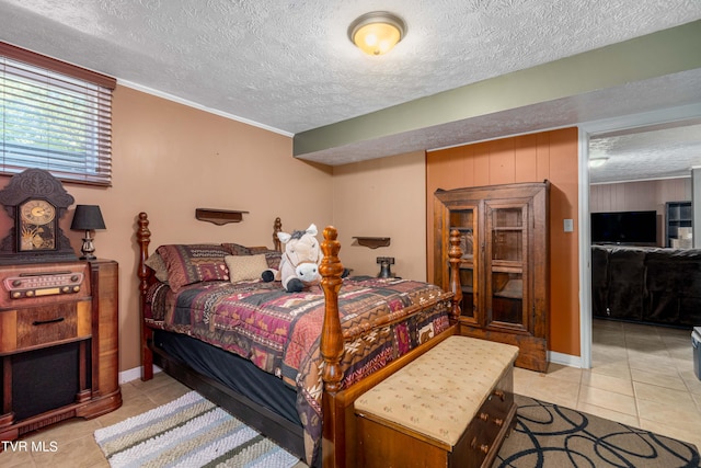 bedroom featuring light tile patterned flooring, crown molding, and a textured ceiling