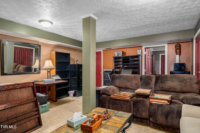 tiled living room featuring a textured ceiling