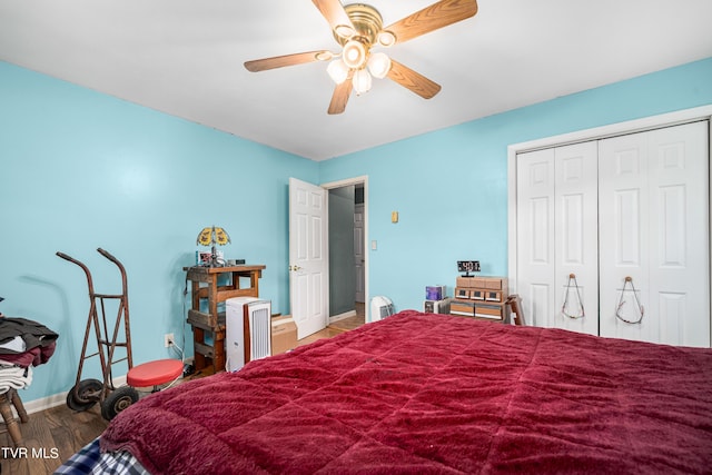 bedroom featuring ceiling fan, wood-type flooring, and a closet