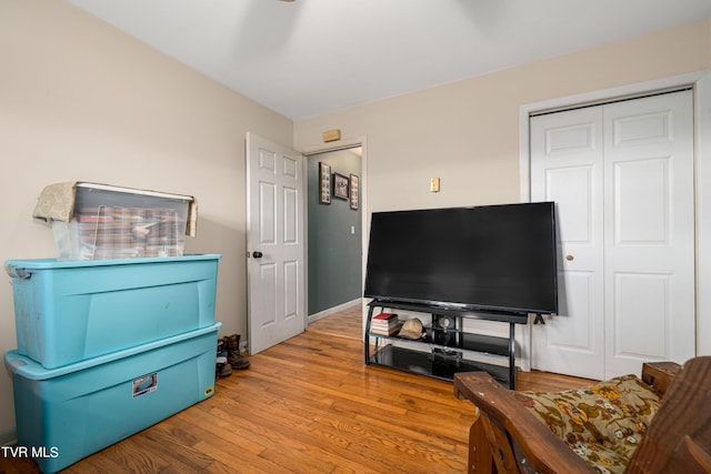 living room featuring light wood-type flooring and ceiling fan