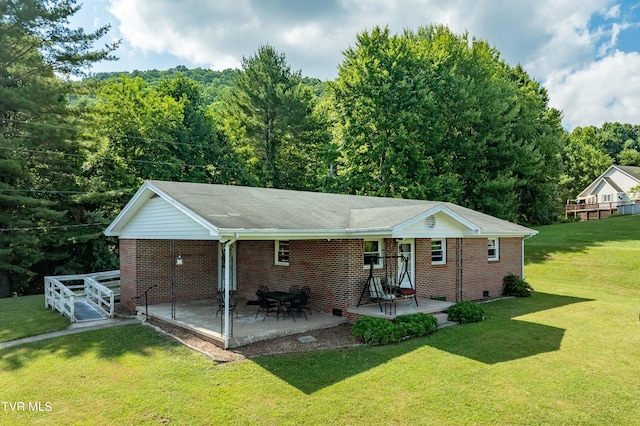 view of front of home with a front lawn and a patio