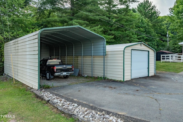 view of outdoor structure with a garage and a carport