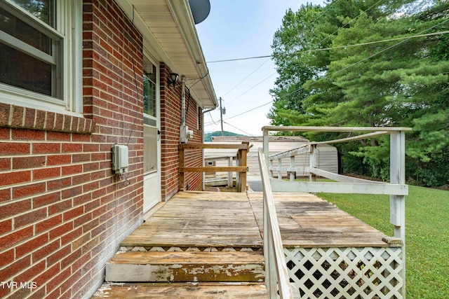 deck with a storage unit and a yard