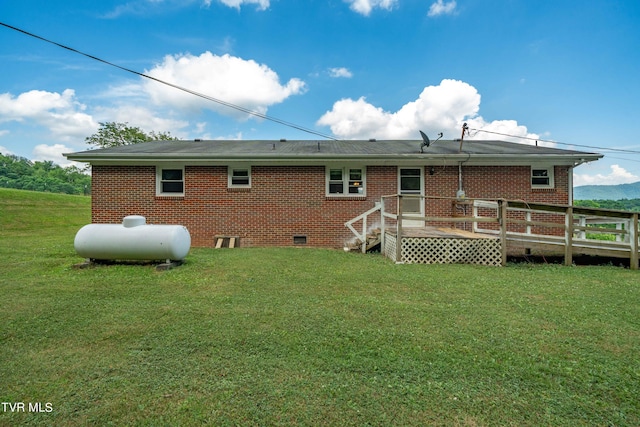 back of house featuring a deck and a yard