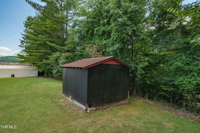 view of outbuilding featuring a yard