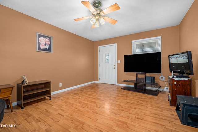 living room featuring light wood-type flooring and ceiling fan