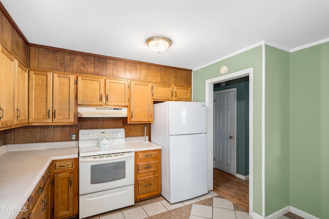 kitchen featuring light tile patterned floors, white appliances, and ornamental molding