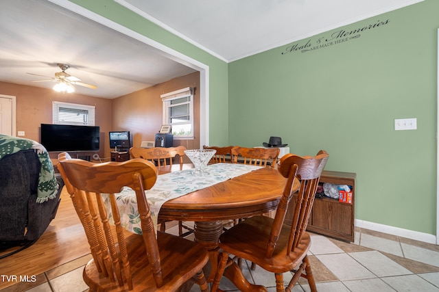 tiled dining room featuring ceiling fan