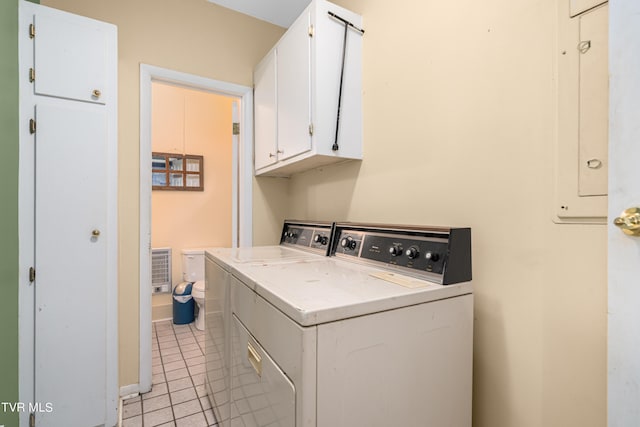 laundry area with cabinets, light tile patterned floors, and independent washer and dryer