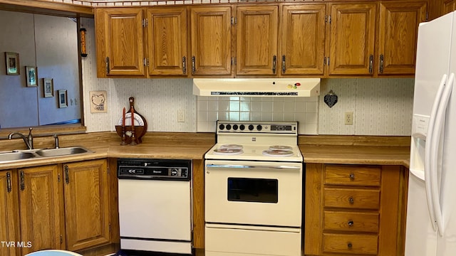 kitchen with decorative backsplash, sink, and white appliances