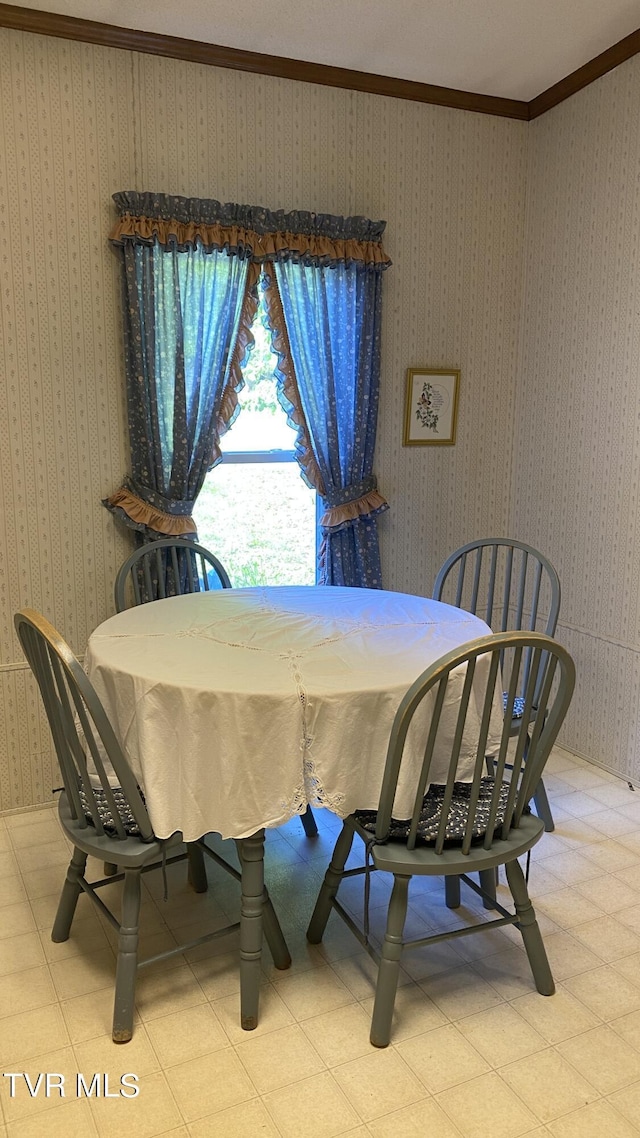 dining room featuring crown molding