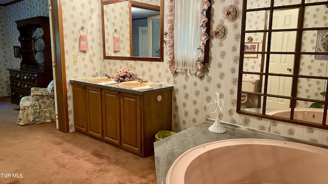 bathroom with vanity and a washtub