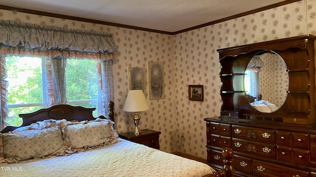 bedroom with a textured ceiling and crown molding