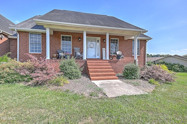 view of front of house with covered porch and a front lawn