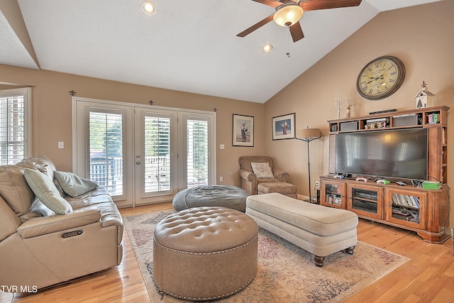 living room featuring high vaulted ceiling, light wood-type flooring, and ceiling fan