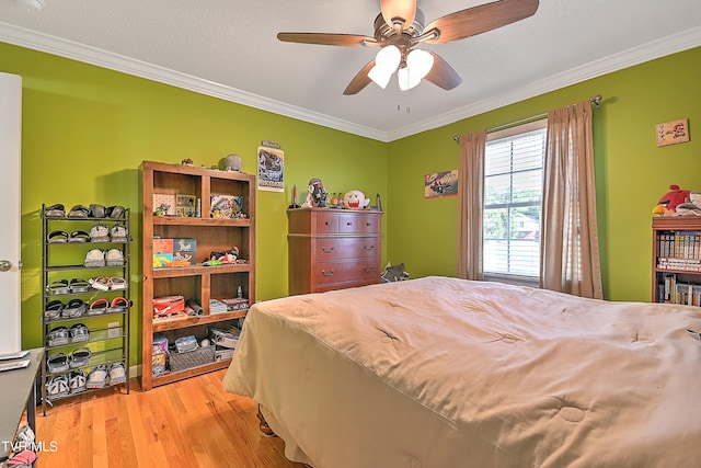 bedroom with crown molding, a textured ceiling, ceiling fan, and wood-type flooring