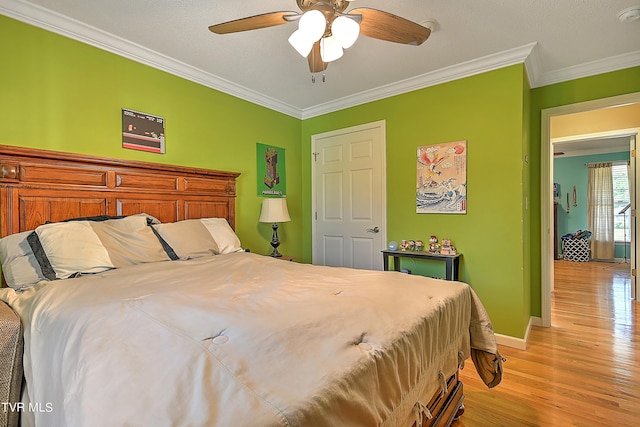 bedroom with ornamental molding, a textured ceiling, ceiling fan, and light wood-type flooring