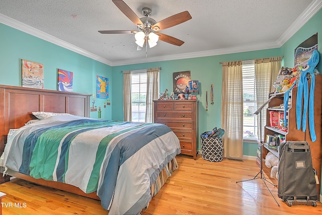 bedroom with multiple windows, ornamental molding, light wood-type flooring, and ceiling fan