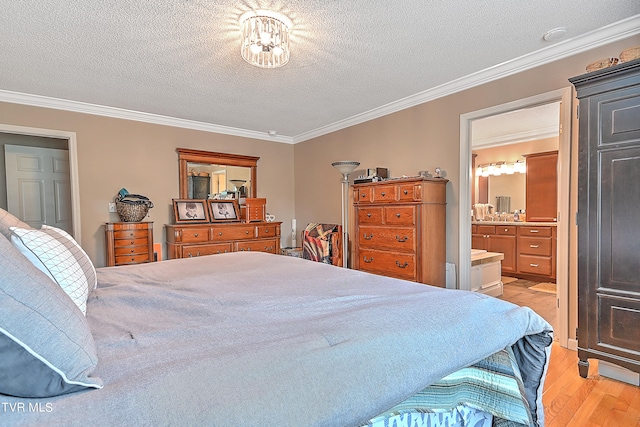 bedroom featuring light wood-type flooring, a textured ceiling, ensuite bath, and ornamental molding