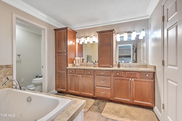 bathroom featuring a relaxing tiled tub, double vanity, a textured ceiling, and toilet