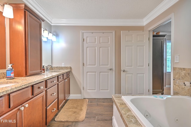 bathroom with a washtub, crown molding, dual bowl vanity, a textured ceiling, and wood-type flooring