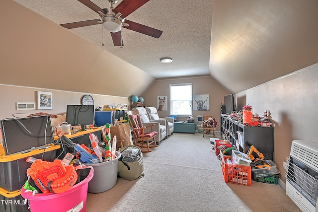 game room with carpet floors, a textured ceiling, ceiling fan, and vaulted ceiling