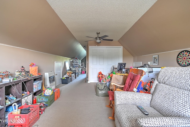 game room featuring a textured ceiling, vaulted ceiling, carpet floors, and ceiling fan