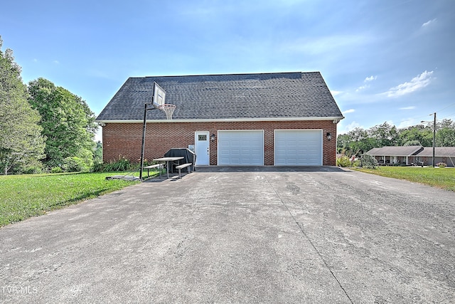 view of home's exterior featuring a garage and a yard