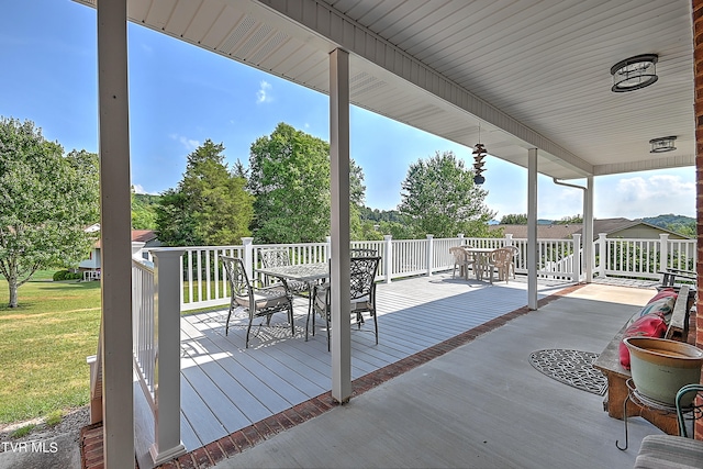 wooden terrace featuring a yard