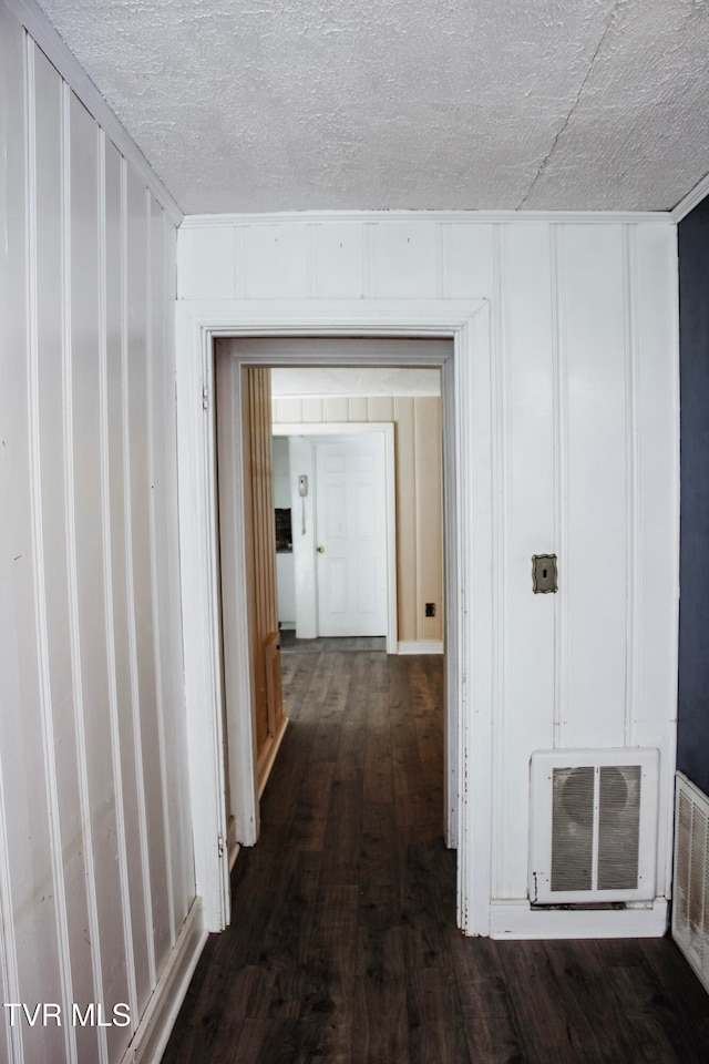 corridor with heating unit and dark wood-type flooring