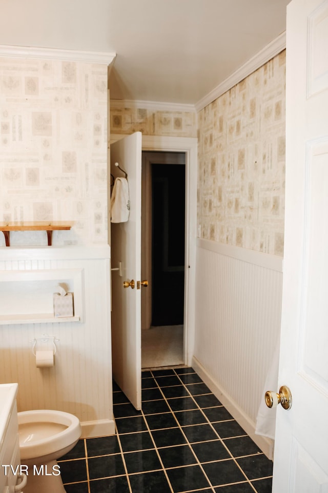 bathroom featuring tile patterned flooring, vanity, toilet, and ornamental molding