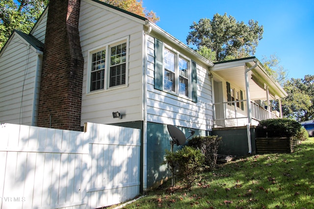 view of side of home with a yard