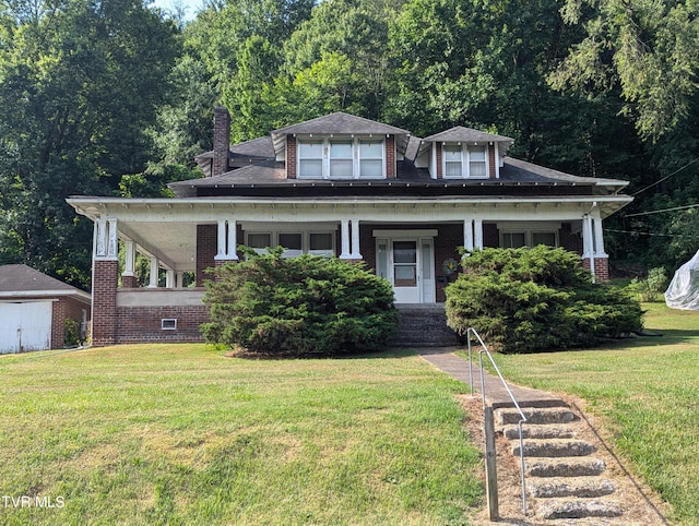 view of front of house with covered porch and a front lawn