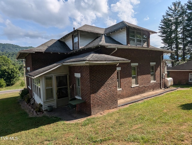 view of side of home featuring a yard