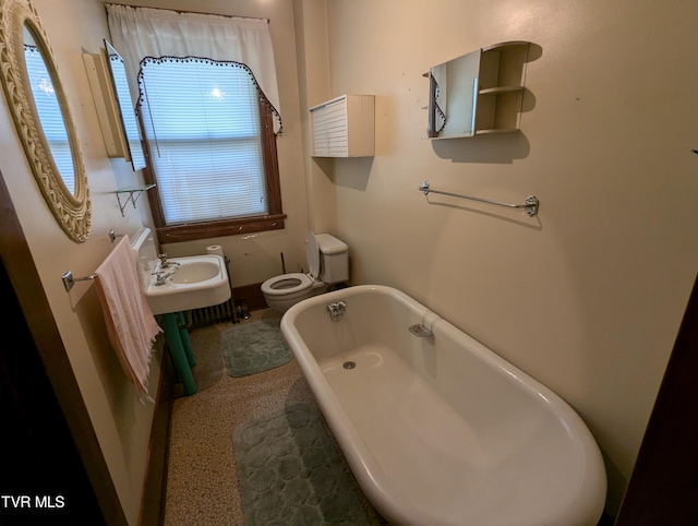 bathroom featuring a bathtub and toilet