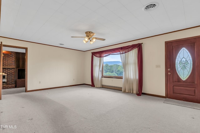 3054 Redbud Hwy, Honaker, VA 24260 - entryway with crown molding, carpet, a ceiling fan, a baseboard radiator, and a brick fireplace