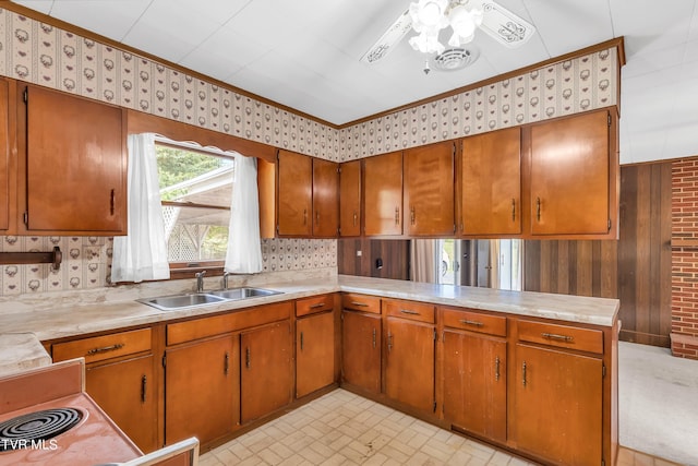 3054 Redbud Hwy, Honaker, VA 24260 - kitchen with light countertops, brown cabinetry, a ceiling fan, ornamental molding, and wallpapered walls