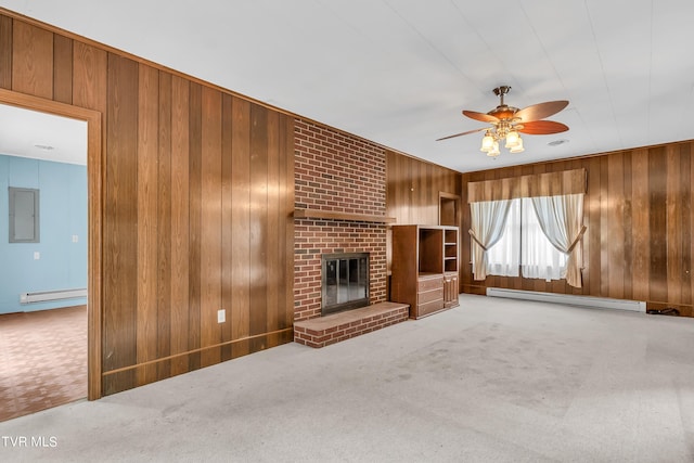 3054 Redbud Hwy, Honaker, VA 24260 - unfurnished living room featuring baseboard heating, wood walls, a baseboard radiator, ceiling fan, and a brick fireplace