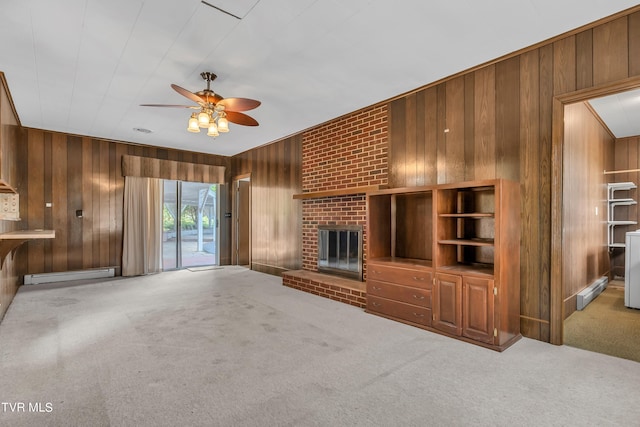 3054 Redbud Hwy, Honaker, VA 24260 - unfurnished living room with wood walls, baseboard heating, a ceiling fan, carpet, and a brick fireplace